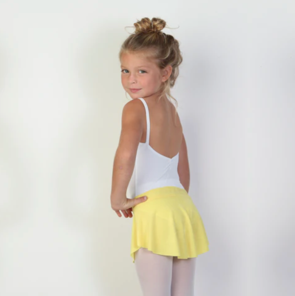 A young ballerina wears a bright yellow flowy Bullet Pointe ballet skirt.