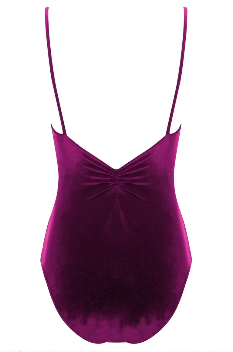 The back of a deep raspberry colored velvet leotard with a pinch detail at the center of the back and spaghetti straps. 